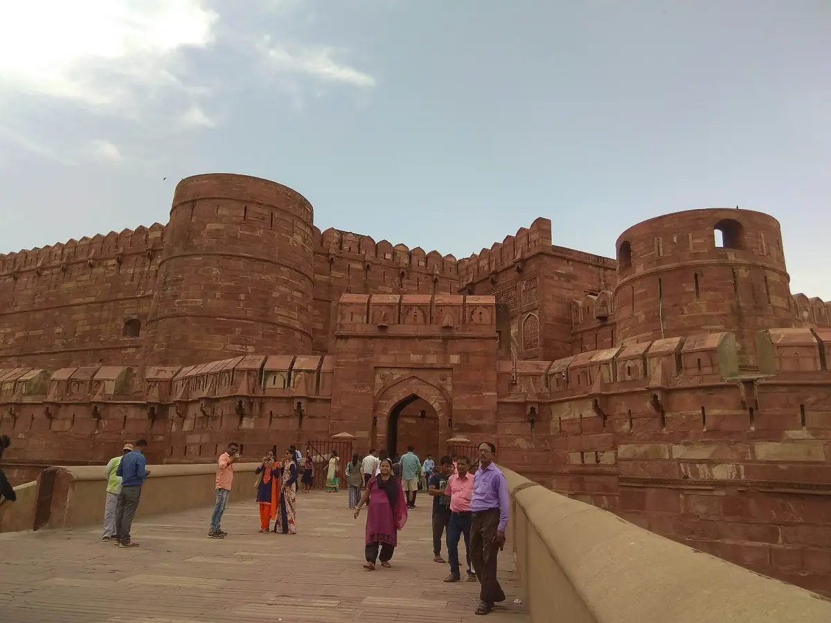 Round towers of Agra Fort gate seen from the approach bridge in daylight