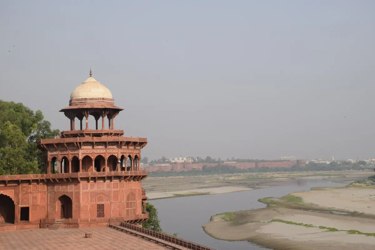Sandstone watchtower of Agra Fort above the Yamuna river in morning haze