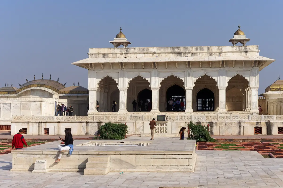 White marble Diwan-i-Khas pavilion with arched openings above a stone terrace